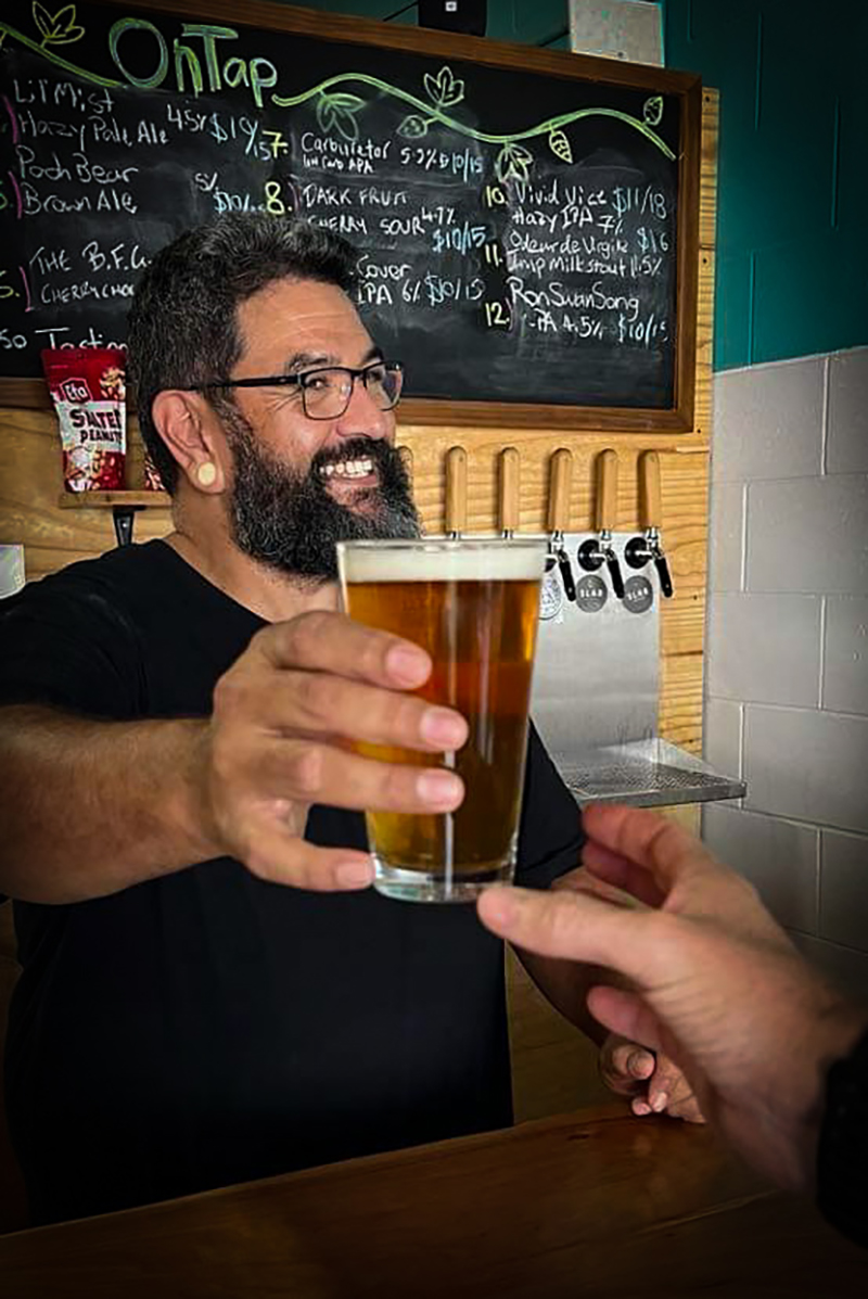 Ed, the brewer at Alchemy Street Brewing, serving a beer
