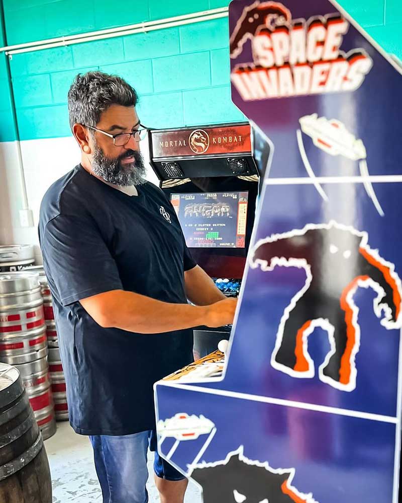 Ed, the brewer at Alchemy Street Brewing, playing one of the free arcade games at the Taproom